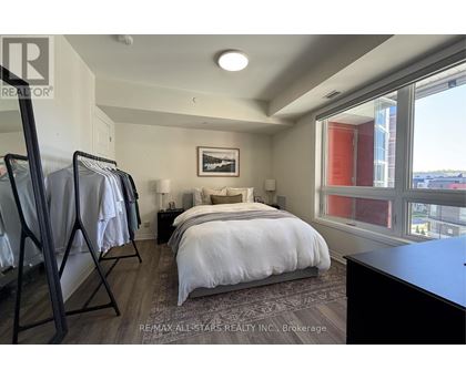 A bedroom with a large bed and a view of the city.