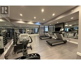 A gym with treadmills, elliptical machines, and other exercise equipment.