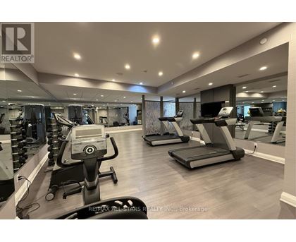 A gym with treadmills, elliptical machines, and other exercise equipment.