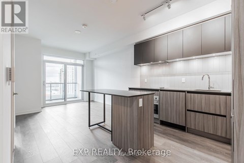 A modern kitchen with wooden cabinets and a large island.