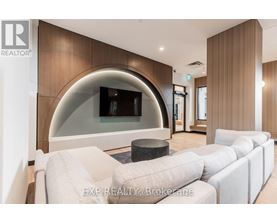 A modern living room with a curved wall and a large white sofa.