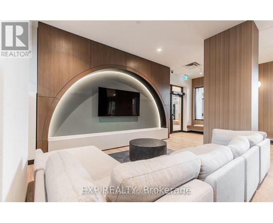 A modern living room with a curved wall and a large white sofa.