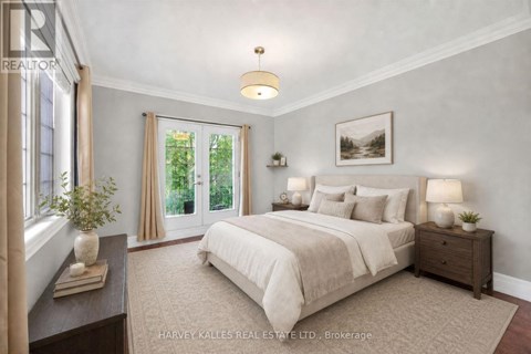 A bedroom with a large bed, a nightstand with a lamp, and a window with curtains.