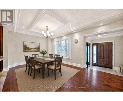 A dining room with a wooden table and chairs.