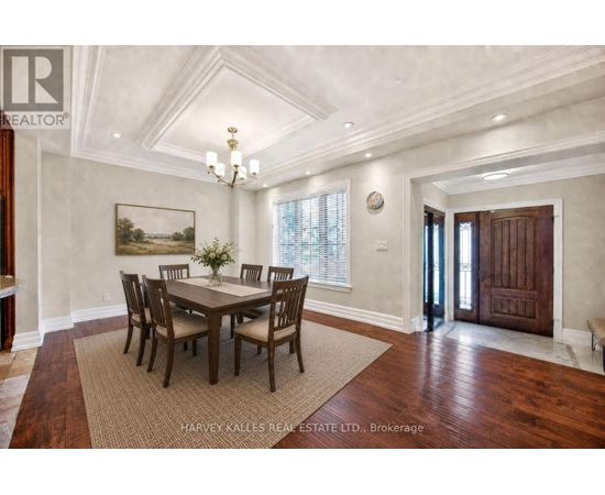 A dining room with a wooden table and chairs.