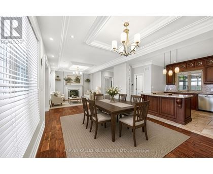 A dining room with a table set for six with a chandelier above.