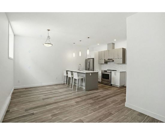 A kitchen with a table and chairs in the middle of the room.