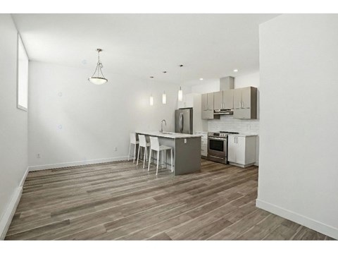 A kitchen with a table and chairs in the middle of the room.