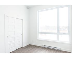 A white door and window in a room with a grey floor.