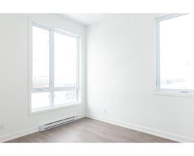 A room with a window and a wall-mounted air conditioner.