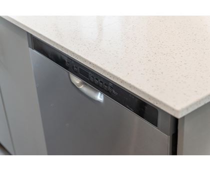 A dishwasher with a silver handle and a white countertop.
