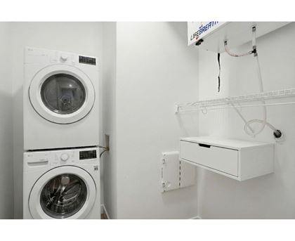 A white washing machine and dryer in a small laundry room.