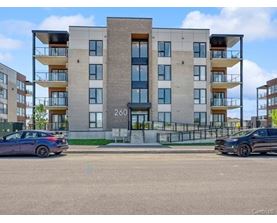 A modern apartment building with the number 200 on the front.