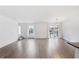 A room with wooden floors and white walls.