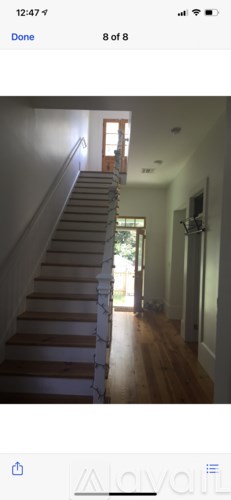 A staircase with wooden steps and white railings.