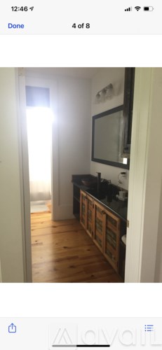 A room with wooden floors and a white door.