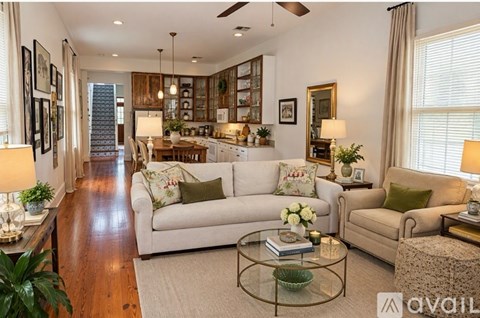 A well-lit, spacious living room with a variety of furniture and decor.