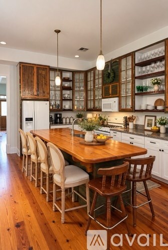 A kitchen with a wooden table and chairs.