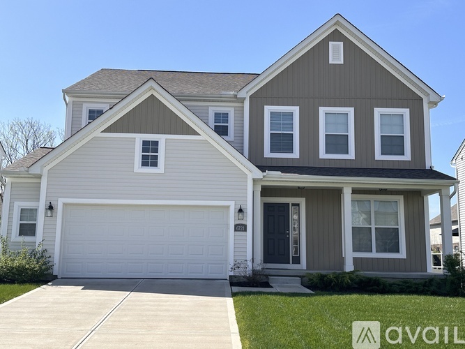 A two-story house with a garage is available for sale.