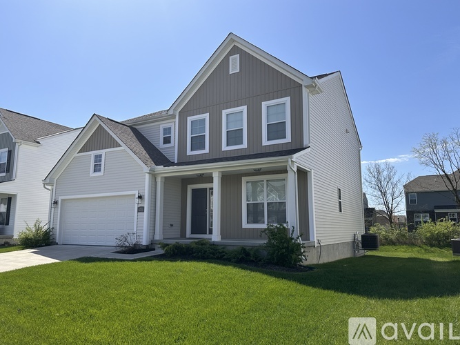 A two-story house with a garage is available for sale.
