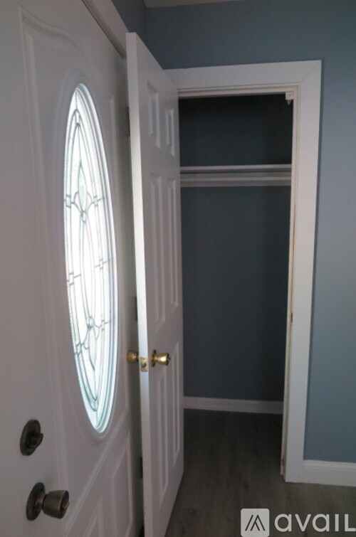 A white door with a glass window is open.