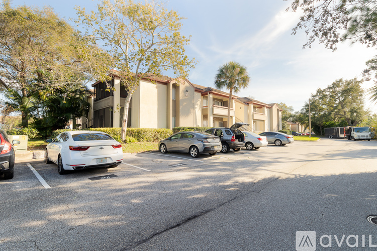A parking lot with cars and a building in the background.