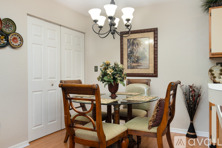 A dining room with a glass table and chairs.