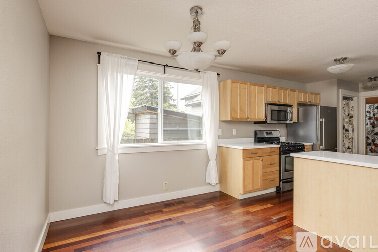 A kitchen with wooden cabinets and a stove top oven.