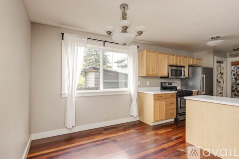 A kitchen with wooden cabinets and a stove top oven.