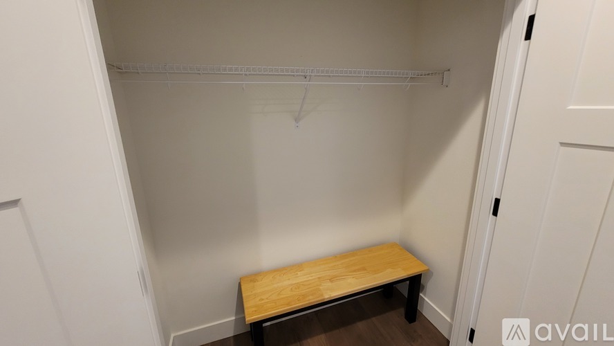 A small closet with a bench inside.