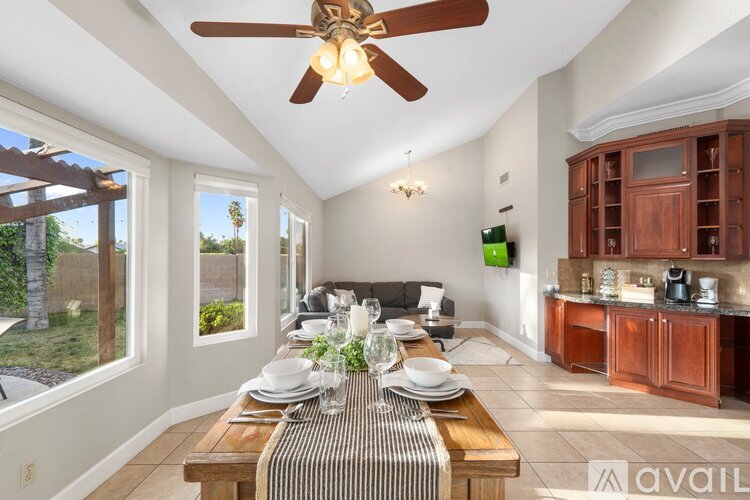 A dining room with a wooden table set for a meal.