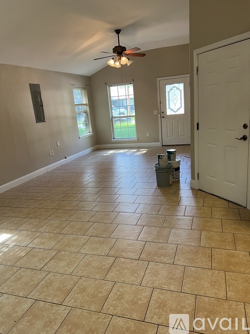 A room with a tiled floor and a ceiling fan.