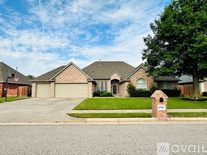 A house with a brick facade and a driveway in front.