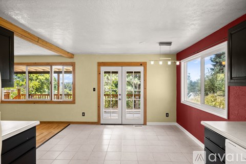 A kitchen with a white counter top and a white tiled floor.