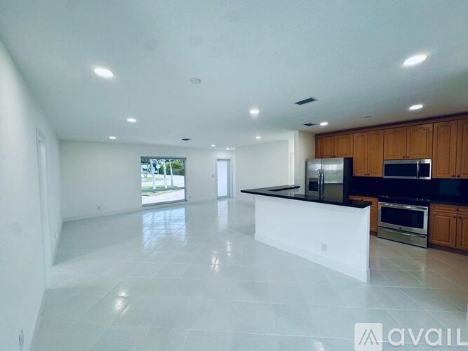 A spacious kitchen with wooden cabinets and stainless steel appliances.