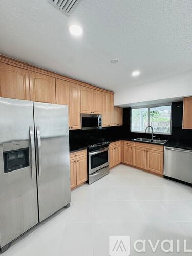 A kitchen with wooden cabinets and stainless steel appliances.