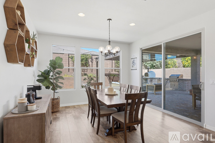 A dining room with a wooden table and chairs.