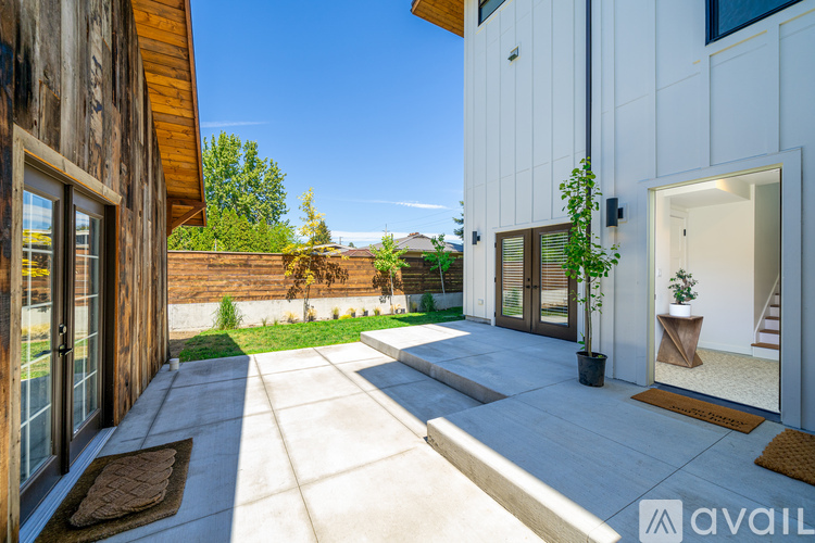 A modern house with a wooden exterior and a white exterior with a glass door.