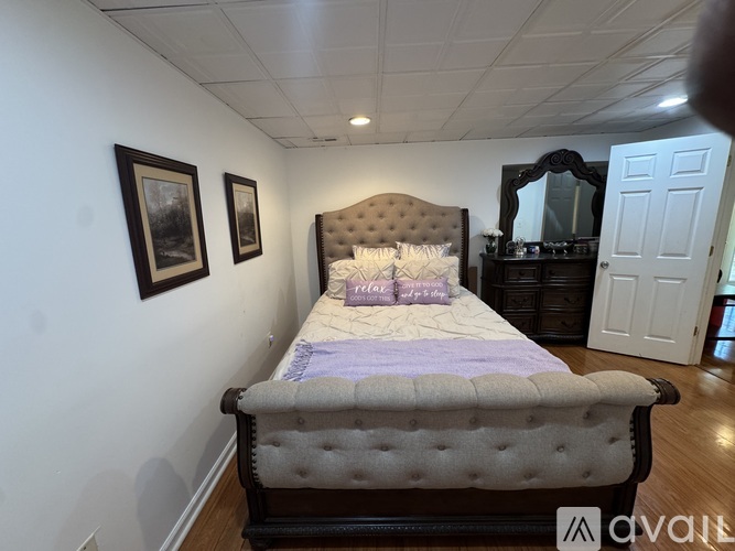 A bedroom with a large bed and a mirror on the wall.