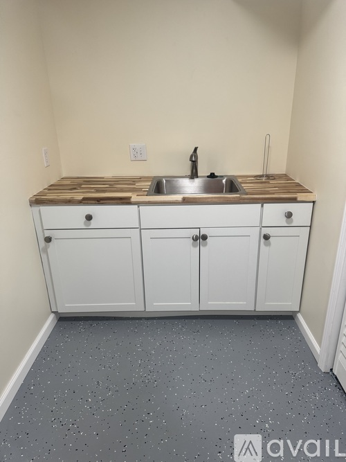 A kitchen with a sink and cabinets.