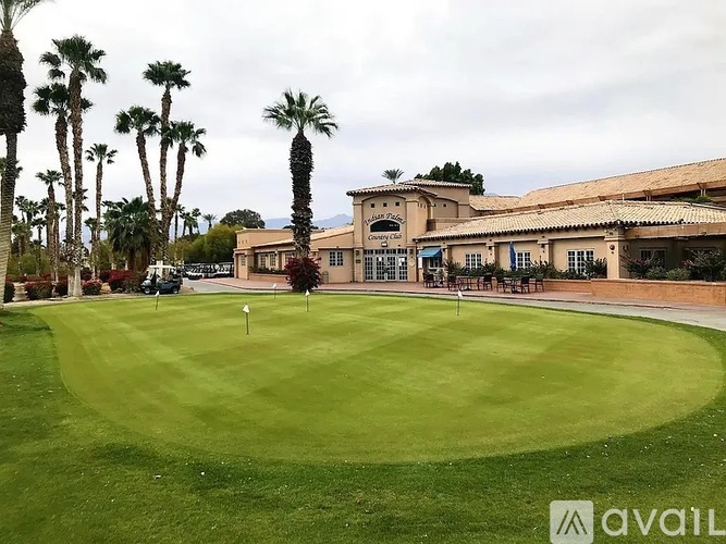 A golf course with a clubhouse in the background.
