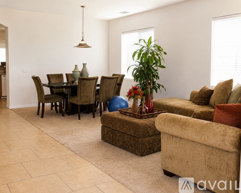 A living room with a dining table and chairs.