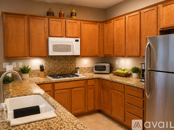 A kitchen with wooden cabinets and granite countertops.