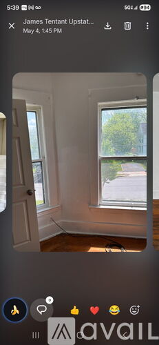 A room with a window showing greenery outside.