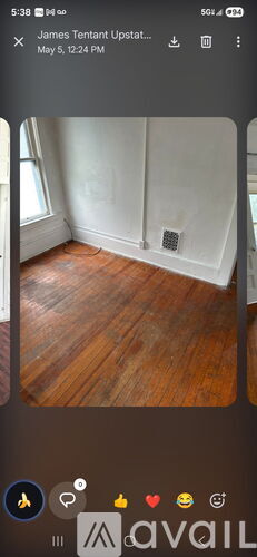 A room with wooden flooring and white walls.