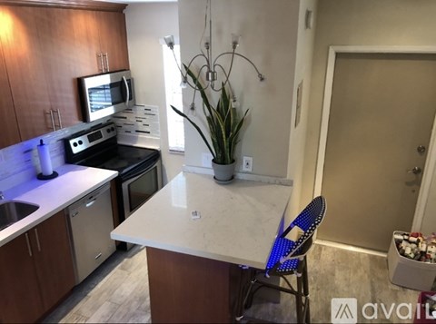 A kitchen with a table and a chair.