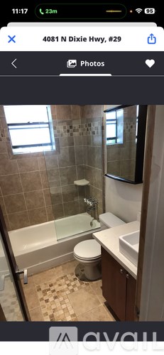 A bathroom with a toilet, sink, and shower.