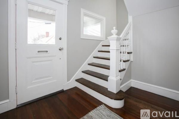 A staircase with a white railing and wooden steps.