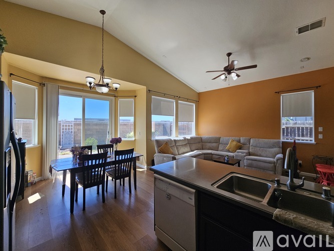 A kitchen with a dining table and chairs is available for rent.