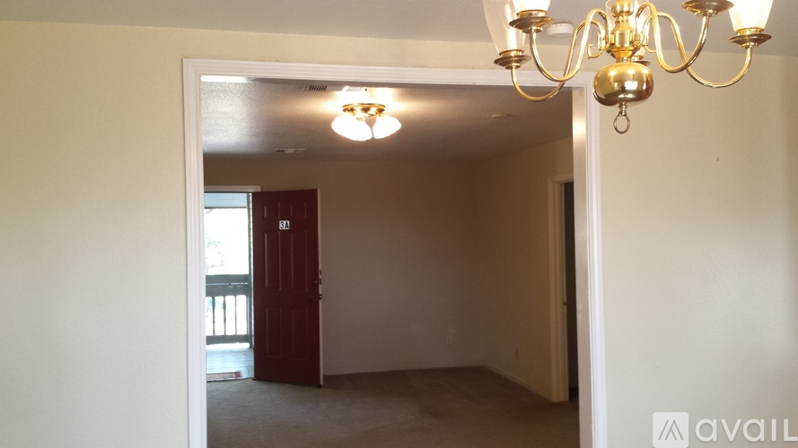 A room with a chandelier and a door.